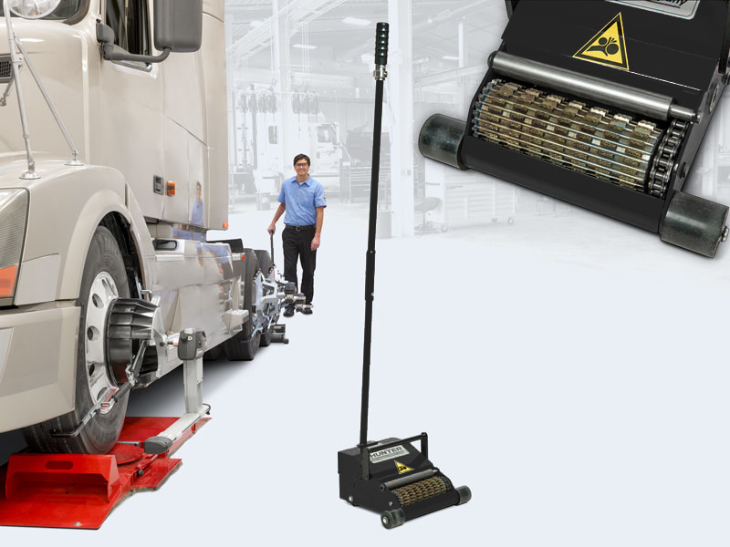 technician performing rolling compensation with truck pusher on semi